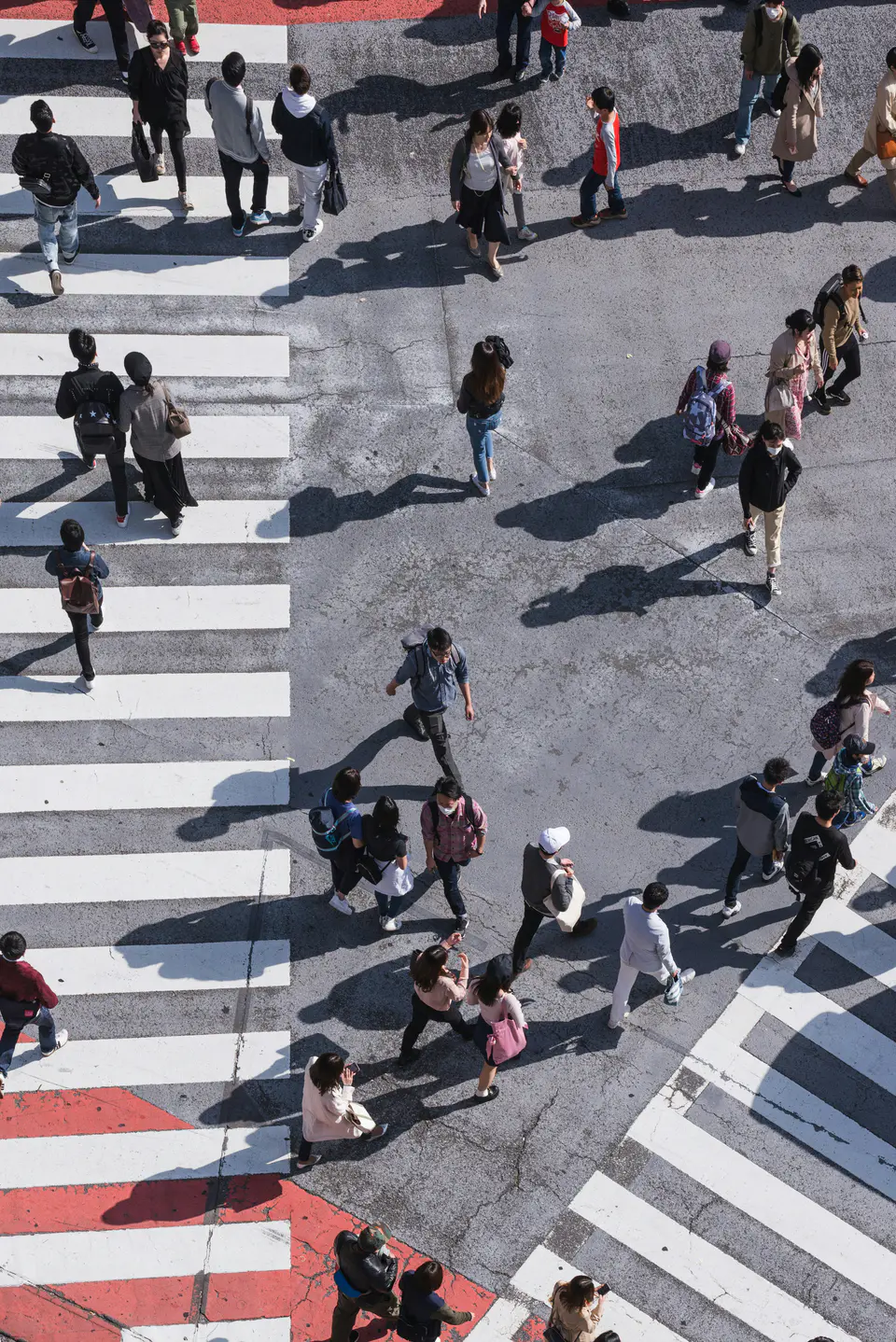 Overhead view of people crossing a city street